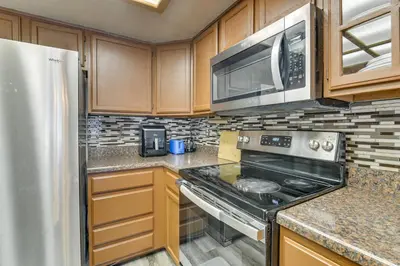 a kitchen with a stove and a microwave at Extended Stay in Denver Area! Pet-Friendly Retreat in Aurora