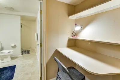 a bathroom with a toilet and a desk and a chair at Extended Stay in Denver Area! Pet-Friendly Retreat in Aurora