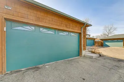 a garage with a blue garage door on a house at Extended Stay in Denver Area! Pet-Friendly Retreat in Aurora