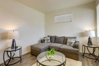 a living room with a couch and two tables at Work and Play! Denver-Area Home with Fenced Backyard in Fort Lupton