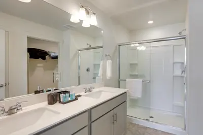 a white bathroom with a sink and a shower at Work and Play! Denver-Area Home with Fenced Backyard in Fort Lupton