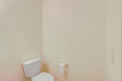 a bathroom with a toilet and a roll of toilet paper at Work and Play! Denver-Area Home with Fenced Backyard in Fort Lupton
