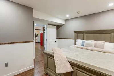 a bedroom with a large bed and a walk in closet at Extended Stay in Denver! Cozy Apartment with Patio in Denver