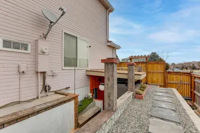 a backyard with a house and a fence at Extended Stay in Denver! Cozy Apartment with Patio in Denver