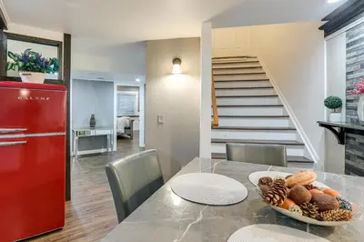 a kitchen and dining room with a table and a red refrigerator at Extended Stay in Denver! Cozy Apartment with Patio in Denver