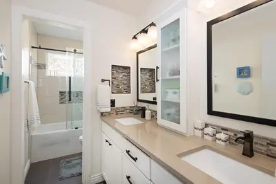 a white bathroom with two sinks and a tub at Mountain View Modern Oasis - Swim Spa -Steam -More in Broomfield