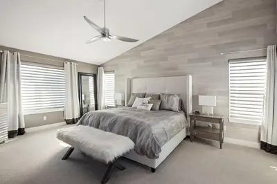 a bedroom with a large bed and a ceiling fan at Mountain View Modern Oasis - Swim Spa -Steam -More in Broomfield