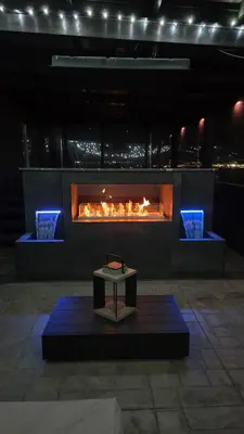 a fireplace with a table in front of it at Mountain View Modern Oasis - Swim Spa -Steam -More in Broomfield