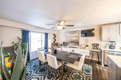 a kitchen and dining room with a table and chairs at Amazing Lake View Heated Pool Swim Spa and Hot Tub in Thornton