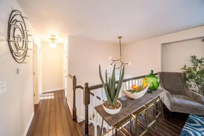 a living room with a table with a plant on it at Amazing Lake View Heated Pool Swim Spa and Hot Tub in Thornton