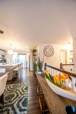 a kitchen and living room with a wooden table at Amazing Lake View Heated Pool Swim Spa and Hot Tub in Thornton