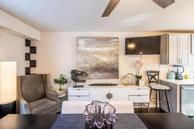 a kitchen and living room with a desk and a chair at Amazing Lake View Heated Pool Swim Spa and Hot Tub in Thornton