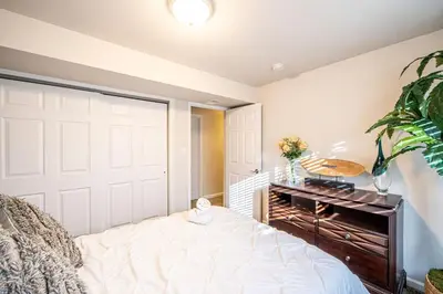 a bedroom with a white closet door and a bed at Amazing Lake View Heated Pool Swim Spa and Hot Tub in Thornton