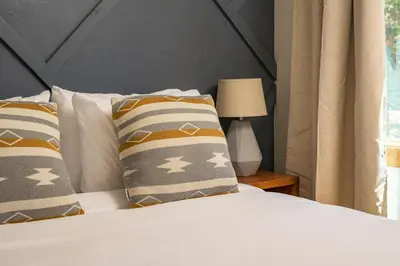 a bedroom with a bed with two pillows and a window at Skyline Lodge with Private Sauna & Hot Tub in Idaho Springs