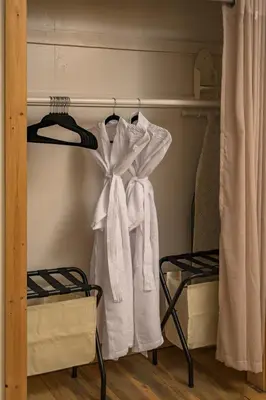 a closet with white towels hanging on a rack at Skyline Lodge with Private Sauna & Hot Tub in Idaho Springs