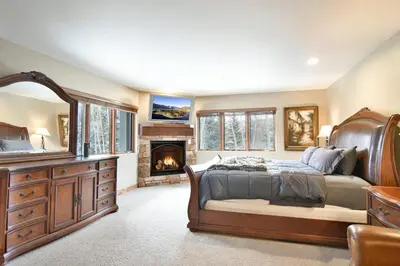 a bedroom with a bed and a fireplace at Marina Park Mountain View Townhome: Heart of Frisco in Frisco