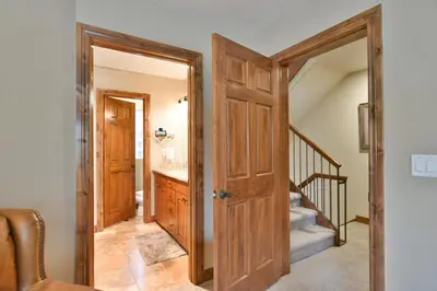 a hallway with a door leading to a bathroom at Marina Park Mountain View Townhome: Heart of Frisco in Frisco