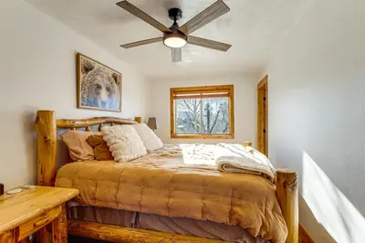 a bedroom with a bed and a ceiling fan at Inviting and Cozy Fraser Condo Steps to Ski Shuttle in Fraser