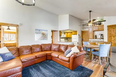 a living room with a brown leather couch at Inviting and Cozy Fraser Condo Steps to Ski Shuttle in Fraser