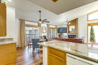 a kitchen and living room with a table and a dining room at Inviting and Cozy Fraser Condo Steps to Ski Shuttle in Fraser
