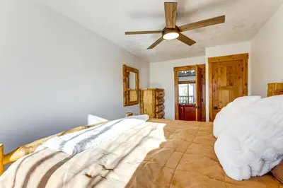 a bedroom with a bed and a ceiling fan at Inviting and Cozy Fraser Condo Steps to Ski Shuttle in Fraser