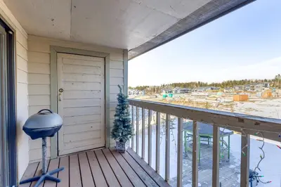 a porch with a door and a christmas tree at Inviting and Cozy Fraser Condo Steps to Ski Shuttle in Fraser