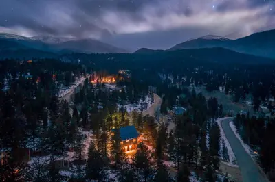 an aerial view of a house in the mountains at night at Royal Elk Lodge Hot Tub Sauna Theatre Speakeasy in Bailey