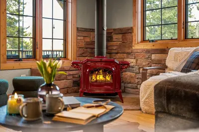 a living room with a red stove in a room at Royal Elk Lodge Hot Tub Sauna Theatre Speakeasy in Bailey