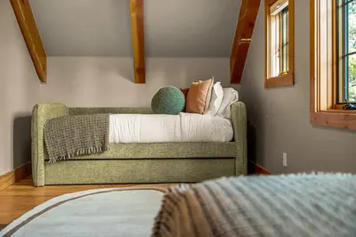 a couch with pillows on it in a room at Royal Elk Lodge Hot Tub Sauna Theatre Speakeasy in Bailey