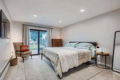 a bedroom with a bed and a chair and a window at FoxGardens Incredible Lake & Mtn View Private Secure in Lakewood
