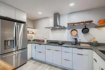 a kitchen with white cabinets and a stainless steel refrigerator at FoxGardens Incredible Lake & Mtn View Private Secure in Lakewood