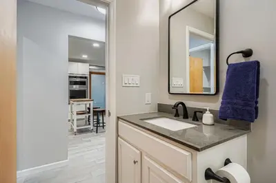 a bathroom with a sink and a mirror at FoxGardens Incredible Lake & Mtn View Private Secure in Lakewood