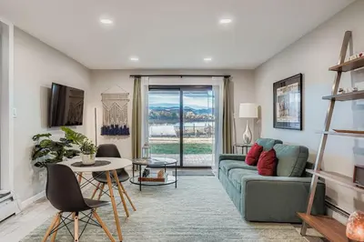 a living room with a couch and a table at FoxGardens Incredible Lake & Mtn View Private Secure in Lakewood