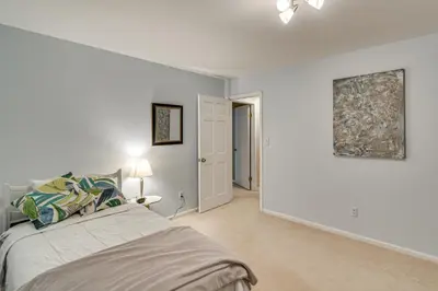 a bedroom with white walls and a bed in a room at Stunning Snowcapped Mtn Views! Evergreen Home in Evergreen