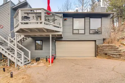 a house with a staircase next to a garage at Stunning Snowcapped Mtn Views! Evergreen Home in Evergreen