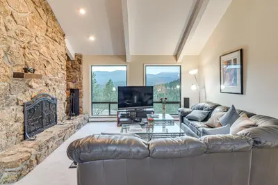 a living room with a couch and a fireplace at Stunning Snowcapped Mtn Views! Evergreen Home in Evergreen