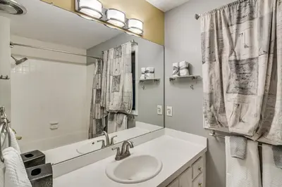 a bathroom with a sink and a mirror at Stunning Snowcapped Mtn Views! Evergreen Home in Evergreen