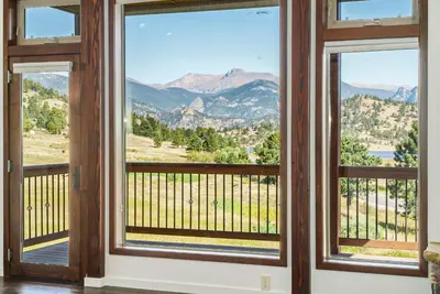a room with windows with a view of mountains at Luxury Mountain Retreat Hot Tub Sauna Views in Estes Park