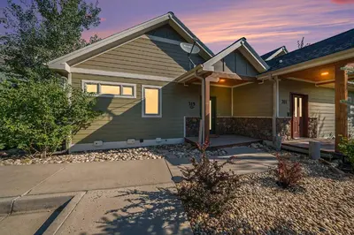 a house with a porch and a driveway at Luxury Mountain Retreat Hot Tub Sauna Views in Estes Park