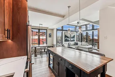 a kitchen and dining room with a dining table at Experience the charm of Frisco in this spacious townhome, Decked Out Downtown, private hot tub in Frisco