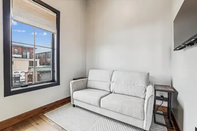 a living room with a couch and a window at Experience the charm of Frisco in this spacious townhome, Decked Out Downtown, private hot tub in Frisco