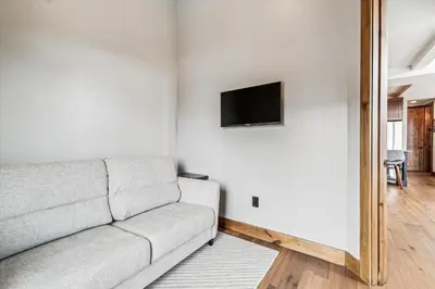a living room with a couch and a flat screen tv at Experience the charm of Frisco in this spacious townhome, Decked Out Downtown, private hot tub in Frisco