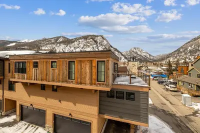 a house in the mountains with snow at Experience the charm of Frisco in this spacious townhome, Decked Out Downtown, private hot tub in Frisco