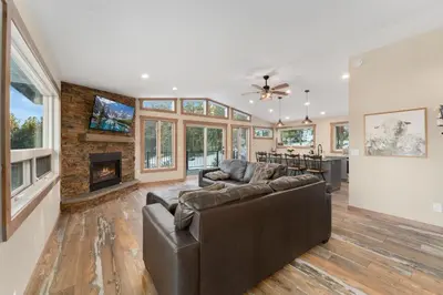 a living room with a couch and a fireplace at The Pine Getaway on 60 Acres with Hot Tub in Pine