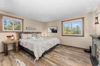 a bedroom with a bed and a fireplace at The Pine Getaway on 60 Acres with Hot Tub in Pine