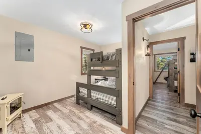 a room with a hallway with wooden floors and a mirror at The Pine Getaway on 60 Acres with Hot Tub in Pine