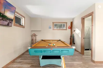 a ping pong table in a room with ahibition at The Pine Getaway on 60 Acres with Hot Tub in Pine