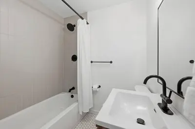 a white bathroom with a tub and a sink at Cozy 2BR Retreat with Backyard Lounge in Aurora