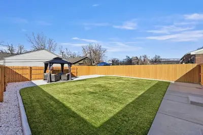 a garden with a gazebo and a fence at Cozy 2BR Retreat with Backyard Lounge in Aurora