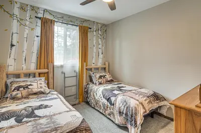 a bedroom with two beds and a window at Hike and Fish Group Getaway with Hot Tub in Bailey! in Bailey